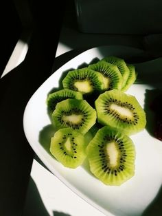 slices of kiwi sitting on a white plate