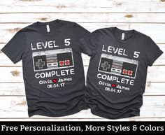 two t - shirts with the words level it complete and an old school video game controller