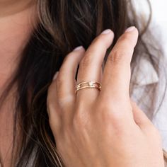 a close up of a person wearing a gold ring