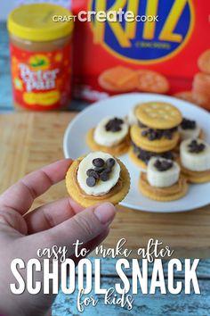 a person is holding up some cookies on a plate with the words easy to make after school snack for kids