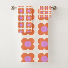 an orange and pink towel hanging on the wall