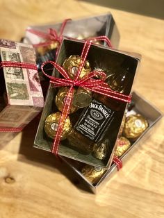 two boxes filled with assorted chocolates on top of a wooden table