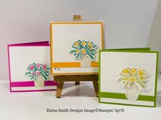 three cards with flowers in vases on easel and one has an easel