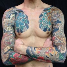 a man with tattoos on his arms and chest