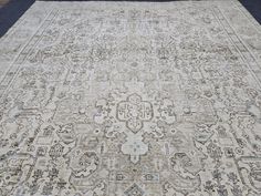 an antique rug is displayed on the ground