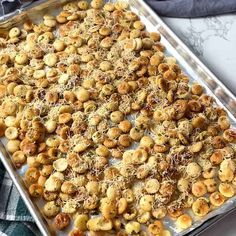 a pan filled with some kind of appetizer on top of a marble counter