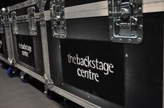 the black stage centre is lined up with metal cases on it's sides for display