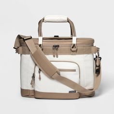 a white and tan bag with straps on the bottom is sitting in front of a white background