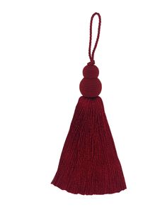 a red tasselled ornament hanging from a string