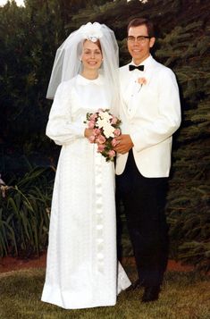 a bride and groom pose for a wedding photo