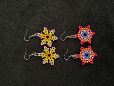 handmade earrings using 2 millimeter seed beads. Multicolor Flower Beaded Earrings For Festival, Multicolor Floral Beaded Earrings For Festivals, Festival Multicolor Flower Beaded Earrings, Bohemian Multicolor Star-shaped Jewelry, Multicolor Beaded Dangle Earrings With Bead Caps, Handmade Multicolor Beaded Earrings In Flower Shape, Multicolor Beaded Dangle Earrings, Handmade Star Earrings For Festivals, Multicolor Beaded Flower Earrings For Festivals