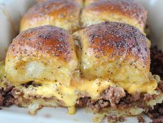 a white plate topped with cheeseburger sliders covered in melted cheese and ground beef