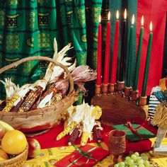 a table with candles, fruit and other items on it