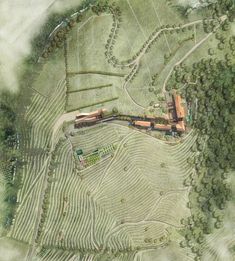 an aerial view of a farm with trees and grass