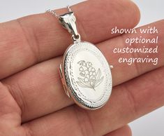 Also available in gold plated/rose gold plated over sterling silver. This elegant customized oval locket will help you keep the memories of your loved ones afresh: 1. One shining, highly polished sterling silver locket. (19 x 26 mm, about the size of a quarter, 4.6 grams). Its front has an etched decorative border. Its back is plain. Both sides can be custom engraved with initial, text or simple graphics.  2. There are two photo slots. Photo insertion service is available for $14 each photo (pricing reflected in your pulldown option. If you select " ... 1/2 photo", please send your locket photos by attaching them to an ETSY conversation to me. 3. a sterling silver or gold filled cross pendant     Upgrade is also available:     https://www.etsy.com/listing/736367470 4. an optional customize Engraved Rose Gold Locket Necklace With Round Pendant, Engraved Rose Gold Round Pendant Locket Necklace, Customizable Silver Locket Necklace For Anniversary, Customizable Silver Locket Necklace For Mother's Day, Rose Gold Locket Jewelry For Personalized Gift, Mother's Day Anniversary Oval Locket Necklace, Classic Oval Personalized Locket Necklace, Classic Personalized Oval Locket Necklace, Personalized Rose Gold Locket Necklace For Memorial