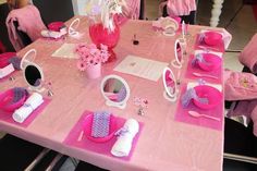 a pink table set up for a birthday party