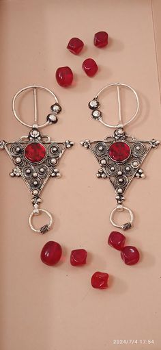 Pair of fibula made of silver and adorned with red gemstone, this UNIQUE piece of jewelry is made to be worn at special events to show love and strong relationship. Size/Dimensions/Weight Style: unique fashion pair of brooches Weight: 20.3 grams for each single brooch (40.6g both) Width: 5.8 cm or 2.28 inch Length: From end to end 11 cm or 4.33 inches long Dear customer, my products get Ornate Red Jewelry Brooch, Traditional Gemstone Brooches As Gift, Traditional Gemstone Brooches For Gift, Traditional Red Brooch For Gift, Traditional Red Brooches For Gifts, Traditional Handmade Red Brooches, Traditional Red Handmade Brooch, Festive Brooch Jewelry, Traditional Handmade Sterling Silver Brooches