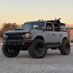 a large gray truck parked on top of a parking lot