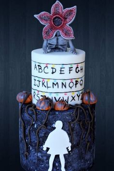 a cake decorated with an image of a person on top and letters written in white