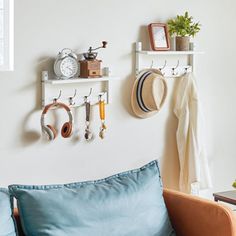 a living room filled with lots of furniture and wall mounted shelves next to each other