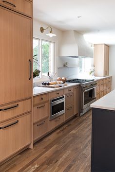 a kitchen with wooden cabinets and stainless steel appliances