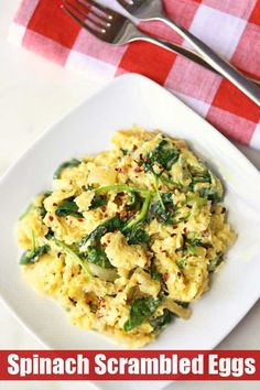 spinach scrambled eggs on a white plate with a red and white checkered napkin