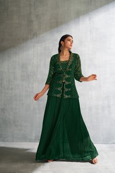 Enrobe yourself in this refined three-piece palazzo set, elegantly attired in green, suitable for special occasions of significance. This ensemble comprises a blouse, bottoms, and an overcoat, each contributing to the ensemble's overall sophistication. The spaghetti-sleeved blouse stands out with printed gold-colored zigzag patterns, artfully complementing the timeless black hue. The overcoat, designed in a blazer style, harmonizes effortlessly with the blouse, presenting matching zigzag patterns along the sleeves and neckline. The plain green palazzo bottoms enhance the ensemble with their voluminous cut, thus concluding a look of refined elegance. Note: Colors may slightly vary due to photographic lighting. Please contact us if you have any questions via email,social media,text or whatsa Palazzo Set, Blazer Style, Zig Zag Pattern, Blazer Fashion, Indian Sarees, Photographic Lighting, Three Piece, Dress Clothes For Women, Favorite Outfit