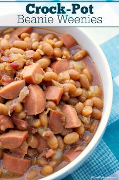 a bowl filled with beans and ham on top of a blue checkered table cloth