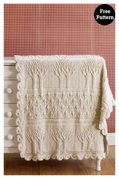 a crocheted blanket is hanging on the wall