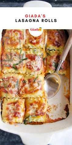 a white casserole dish filled with lasagna rolls and a serving spoon