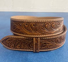 ABOUT THE ITEM:   - This belt is made of top quality genuine leather. - Custom engrave option. - Easy Snap-On system to change the custom buckle. - 1.5" (38mm) wide. Adjustable Artisan Leather Belt Buckles, Adjustable Hand-tooled Leather Belt, Classic Adjustable Hand Tooled Belt, Classic Adjustable Hand-tooled Belt, Classic Hand Tooled Brown Belt Buckles, Classic Hand Tooled Leather Belt Buckles, Engraved Leather Belt Buckles, Adjustable, Classic Brown Hand Tooled Belt Buckles, Classic Hand Tooled Leather Belt