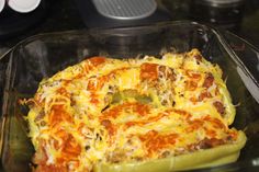 a casserole dish with cheese and vegetables in it on a counter top, ready to be eaten