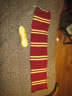 a harry potter scarf next to a banana on the floor