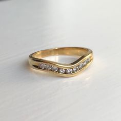 a gold ring with three diamonds on it