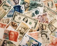 many different types of money are scattered together