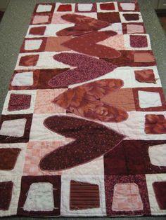 a quilted table runner with an abstract design