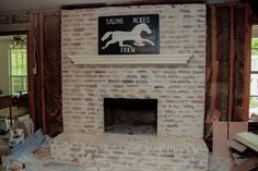 a brick fireplace with a sign above it