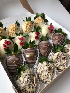 a box filled with chocolate covered strawberries on top of a table