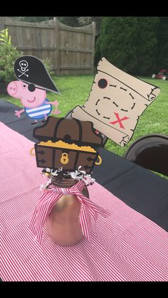 the table is set up for a pirate birthday party with paper cutouts on it