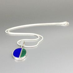 "Oval modern pendant Lapis lazuli and Malachite set in Sterling siver with silver chain. Unique gift for her or him, friend, September and December birthstone, anniversary gift. Very nice classic pendant, with a modern touch. The pendant is divided in two parts, the bigger being Lapis and a smaller with Malachite. This beautiful pendant is worked with the technique of inlay, which means the stone is worked seamlessly into the Sterling silver. The 2.5mm loop is suitable for every chain and standa Modernist Blue Jewelry As Gift, Blue Modernist Jewelry For Gift, Modernist Blue Jewelry For Gift, Modernist Blue Jewelry Gift, Modern Blue Oval Necklace, Modern Blue Necklace With Polished Finish, Modern Blue Necklaces With Polished Finish, Work Gifts, Mens Pendant