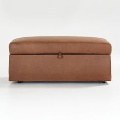 a brown leather bench with wheels on the bottom and one foot resting on it's side