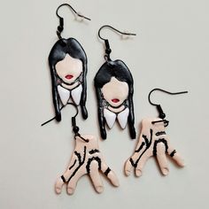 Wednesday and Thing earrings, mix and match. Handmade with clay,  paint, and sealed with gloss. Earring hooks are hypoallergenic  size is approx 2 inches  Please note since these are handmade there may be slight variations Wednesday Addams Inspired Jewelry, Addams Family Earrings, Addams Family Polymer Clay, Beetlejuice Clay Earrings, Beetle Juice Polymer Clay Earrings, Addams Familie, Addams Family, Halloween Earrings, Clay Earrings