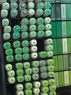 there are many green and white buttons on the shelf