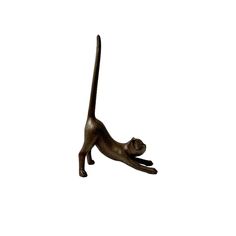 a bronze statue of a cat on its hind legs, with one paw in the air