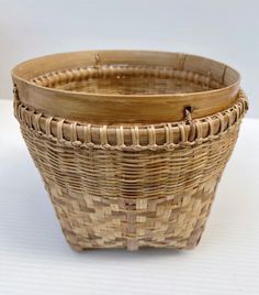 two wicker baskets sitting next to each other on a white tableclothed surface