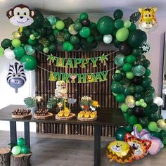 a jungle birthday party with balloons and decorations