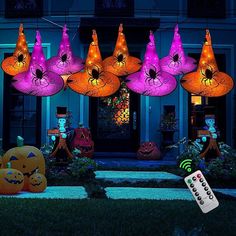 halloween decorations are lit up in front of a house