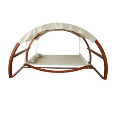 a wooden swing bed with white sheets on it