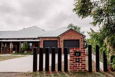 a brick house with a metal fence around it