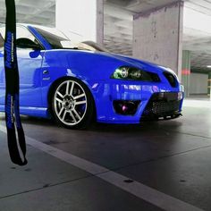 a blue car parked in a parking garage